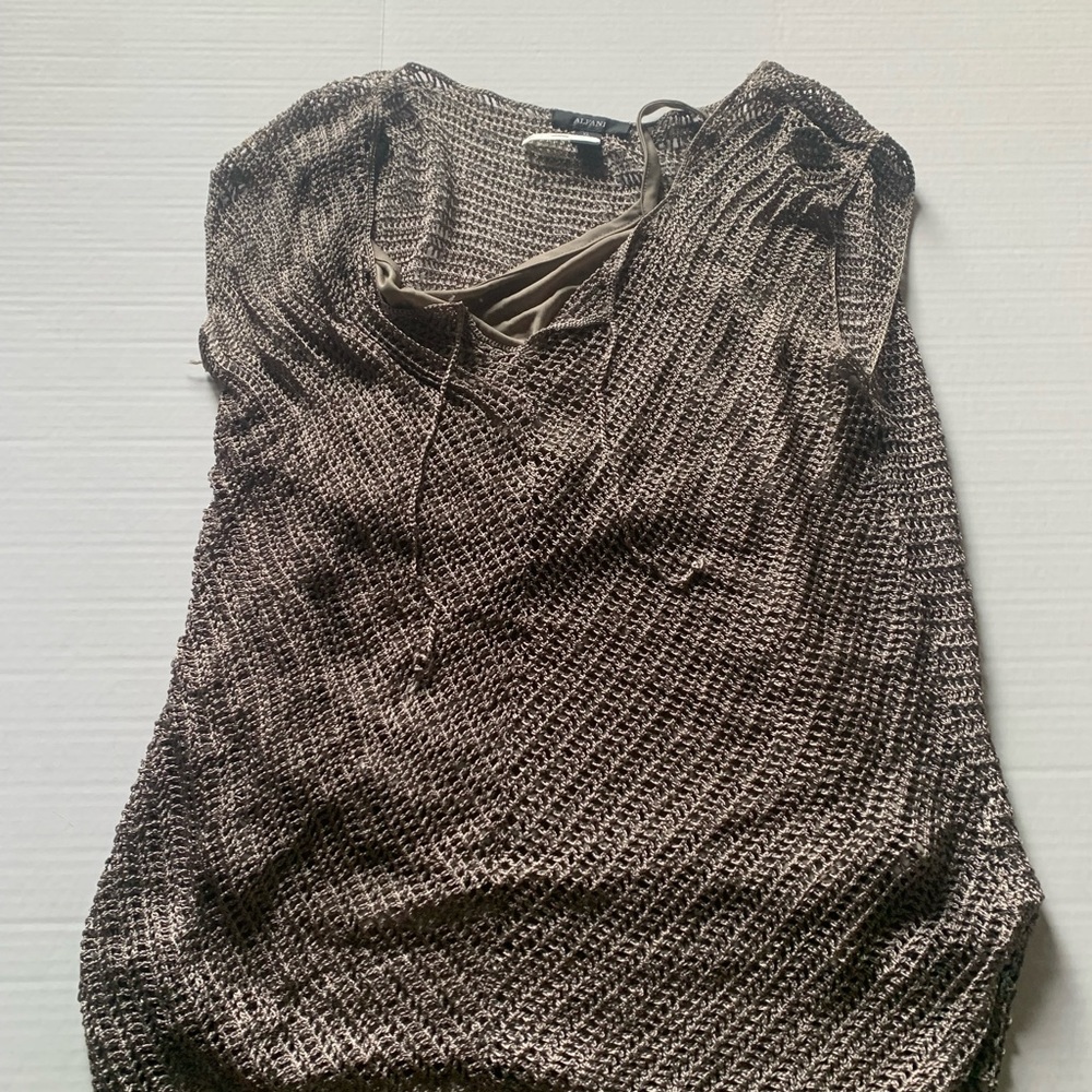 Crochet top with a camisole underneath. Beautiful and festive for a evening wear